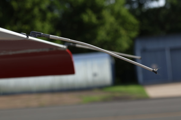Close-up of the brush-like exposed conductive fibers at the discharge end of a flexible aircraft static wick