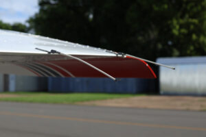 Multiple static wicks mounted on the trailing edge of an aircraft wing and control surfaces