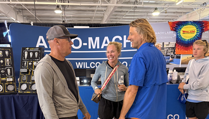 Customers visit tradeshow booth during EAA AirVenture